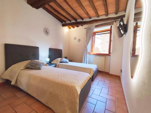 a bedroom with two beds in a room at Le Torri 3 San Gimignano in San Gimignano