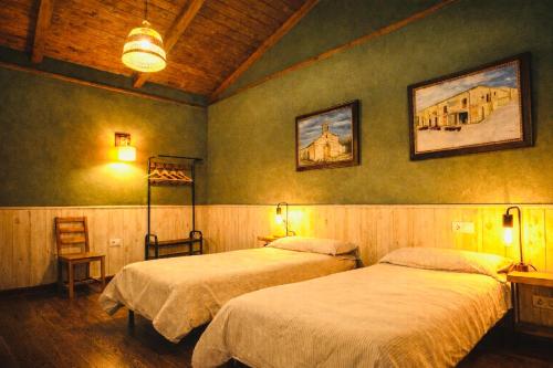 a bedroom with two beds in a room at Casa Barbadelo in Sarria