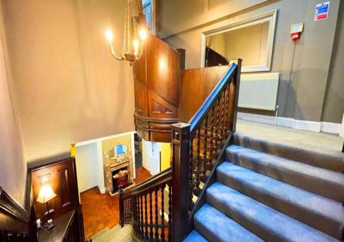 a spiral staircase in a building with a stair case at Edinburgh Country Estate Rooms & Apartments in Gorebridge
