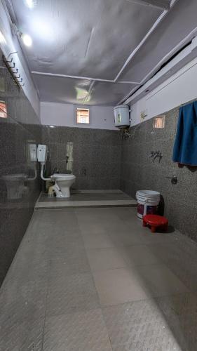 an empty bathroom with a toilet and a sink at Raj guest House in Chitkal