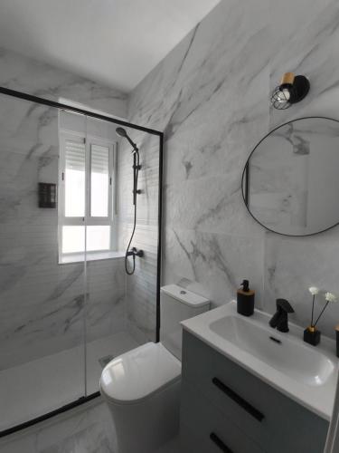 a bathroom with a toilet and a sink and a shower at Casa Molino San Antonio in Córdoba