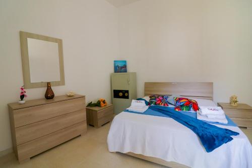 a bedroom with a bed with a mirror and a dresser at Elaia's House in Cannole in Cannole