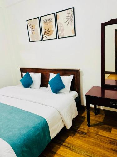 a hotel room with two beds and a table at Highest Village Bungalow in Nuwara Eliya