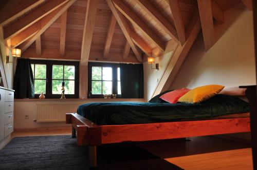 a bedroom with a large bed in the attic at SLEEP INN Bed&Breakfast in Amblève