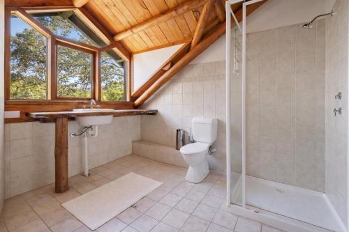 a bathroom with a toilet and a shower and a sink at Yallingup Surfing wineries and restaurants in Yallingup