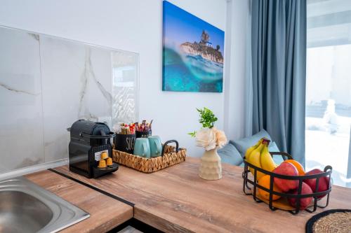 a kitchen counter with fruit on top of it at Odaria Premium Apartments in Lampi