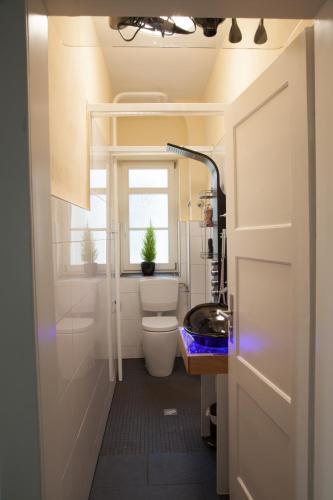 a bathroom with a toilet and a sink and a window at Gästehaus-Fulda in Fulda