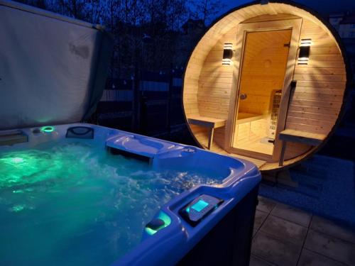 a jacuzzi tub with a sauna in a backyard at Willa Jaworzynka 1103 K Wisły in Jaworzynka