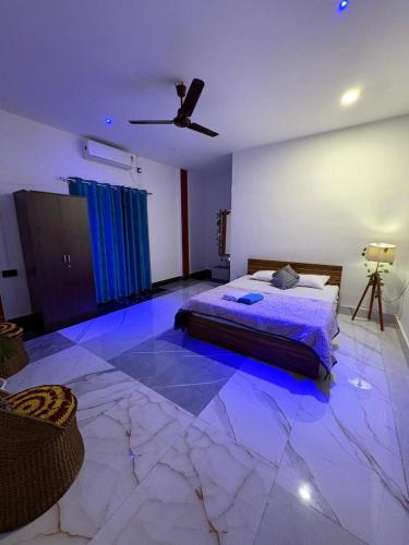 a bedroom with a bed and a ceiling fan at Vasudha Homestay in Sibsāgar