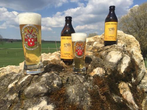 three bottles of beer sitting on a rock at Speidel´s BrauManufaktur in Ödenwaldstetten
