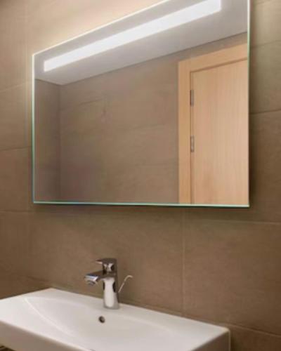 a bathroom sink with a large mirror above it at Apparemment à Radisson Blu Apartment Alhoceima Beach Access in Al Hoceïma