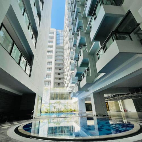 a building with a pool in the middle of it at Hotel Grand Pacific in Cox's Bazar