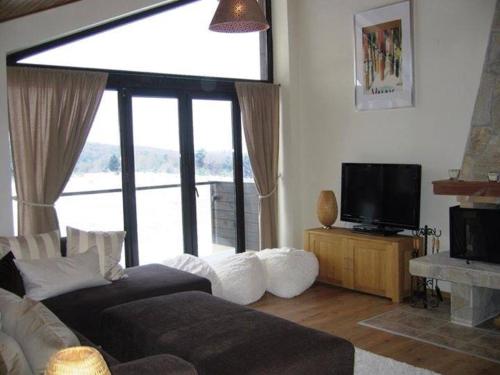 a living room with a couch and a television at Chalet Mechka in Borovets