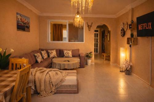 a living room with a couch and a table at 2BR Luxury Apartment-Heart Of Taghazout, Private Beach Access, Panoramic View, Remote Work 100Mbps, Walk to Restaurants in Taghazout