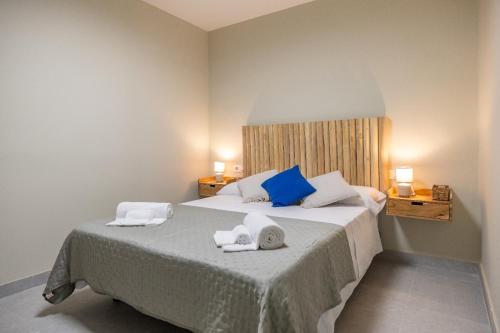 a bedroom with a bed with towels on it at Carmen Beach Hostel Cullera in Cullera