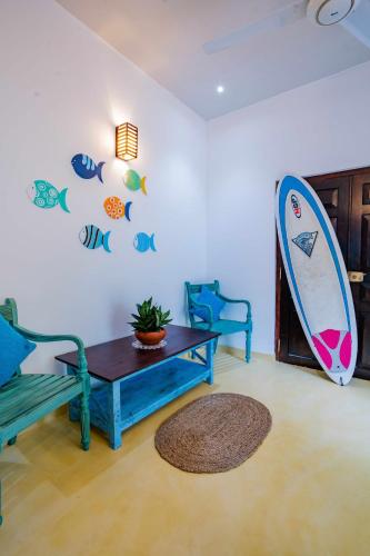 a living room with a surfboard on the wall at Glamour Mirissa in Mirissa