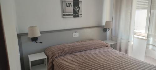 a bedroom with a bed with a brown blanket at HOSTAL RESTAURANTE MILAN II in San Clemente