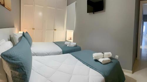 a hotel room with two beds and a television at Casa de Silvia in Arrecife