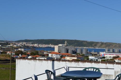 a table and chairs on a roof with a city at Casa de Santa Catarina in Cabo da Praia