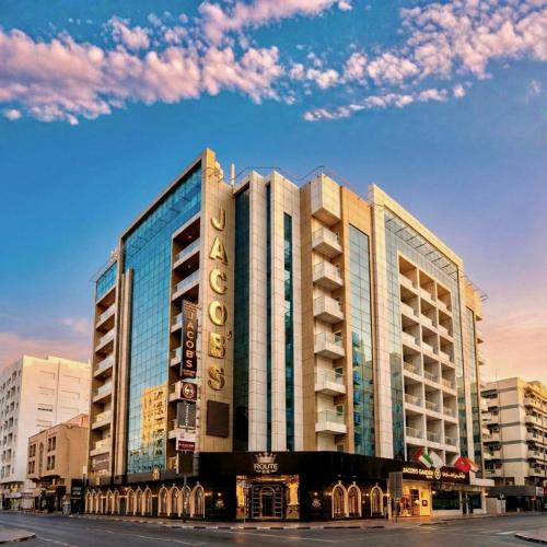 a building with a sign on the side of it at Jacob's Garden Hotel in Dubai