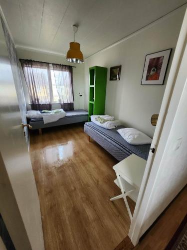 a small room with two beds and a table at Evita in Kosta