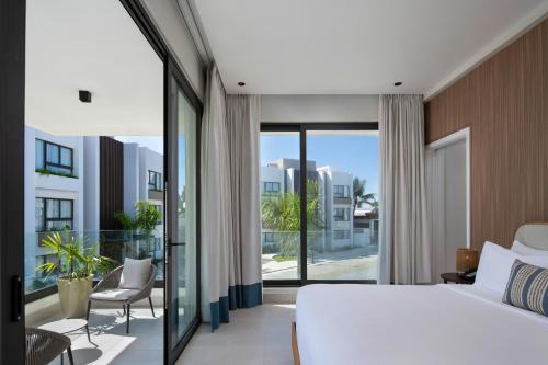 a bedroom with a bed and a balcony at Donoma Las Terrenas Resort & Villas, Autograph Collection in Las Terrenas