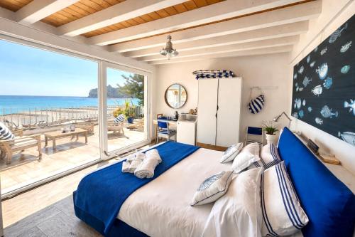 a bedroom with a large bed with a view of the ocean at Il Profumo del Mare GuestHouse in Cagliari