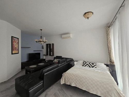a living room with a couch and a bed at Apartment Pasha in Pržno