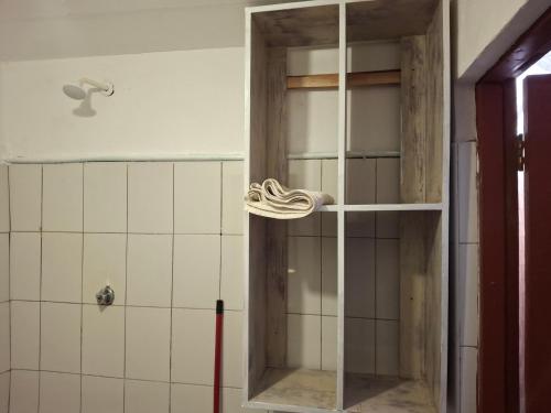a glass cabinet in a bathroom with a shower at Susans cottages diani beach in Ukunda