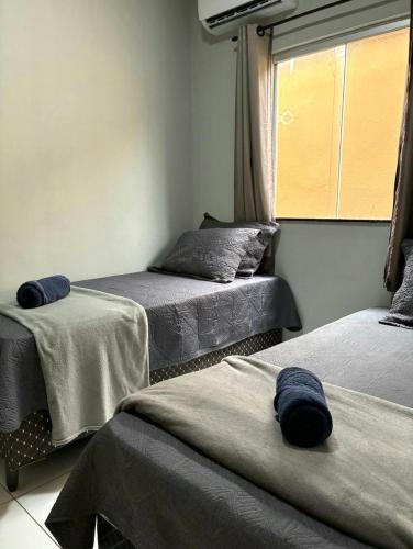 a room with two beds and a window at Dunas residence casa 04 in Santo Amaro