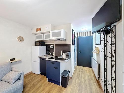 a small kitchen with a sink and a refrigerator at Studio avec terrasse in Amiens