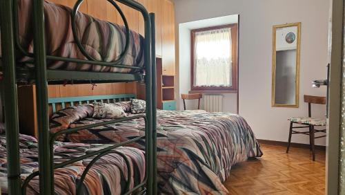 a bedroom with a bunk bed with a cat laying on it at Casa Angelo in Torri del Benaco