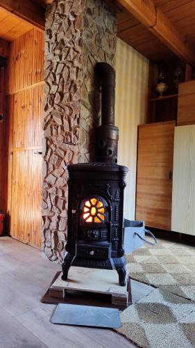 a black stove in a room with a stone wall at Chata Seč II in Bojanow