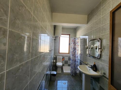 a bathroom with a sink and a toilet at Jozi Kaiser Apartment 2 in Durrës