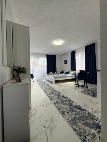a large living room with a bed and a table at EFESA Apartments in Visoko