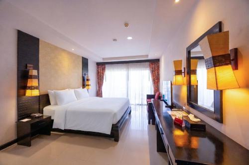 a hotel room with a bed and a television at Horizon Karon Beach Resort & Spa in Karon Beach