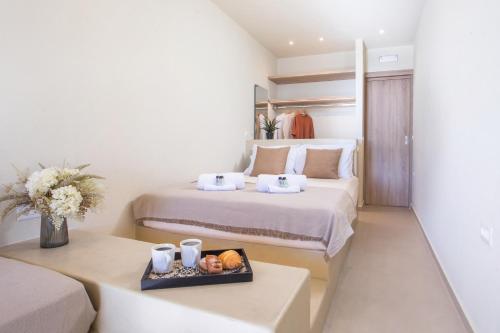 a hotel room with two beds and a tray of food at Charaki Rest Point in Haraki