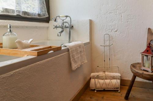 a bathroom with a sink and a table with a lamp at Bnbook Ca Du Val in Falmenta