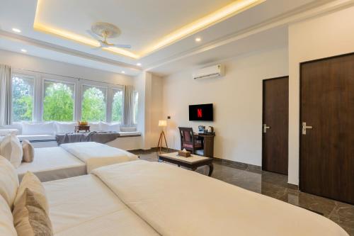 a living room with two white beds and a couch at Virasat-1969 in Udaipur