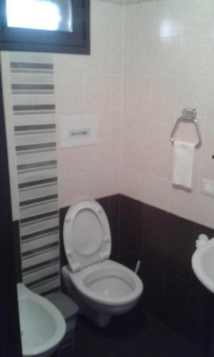 a bathroom with a toilet and a sink at Antica Vittoria in Vittoria