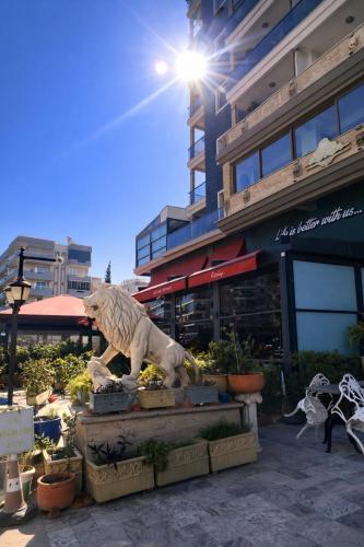 a statue of a tiger in front of a building at Lion Park Suites & Residence Hotel in Aydın