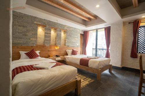 a bedroom with two beds in a room at Hotel Mera Peak Private Limited in Pokhara