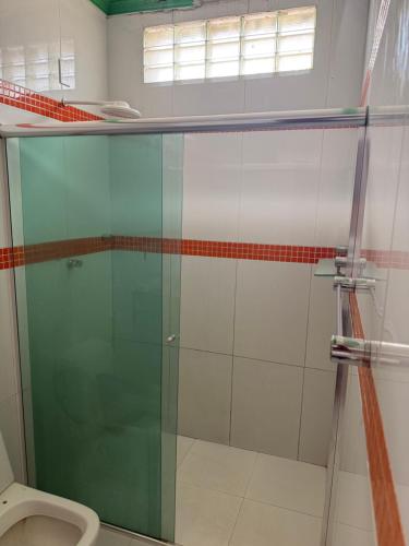 a bathroom with a glass shower with a toilet at Guest House da Amazônia in Manaus
