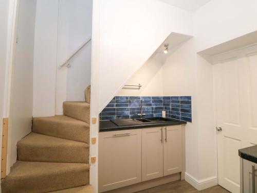 a small kitchen with stairs in a house at Natures Retreat in Matlock