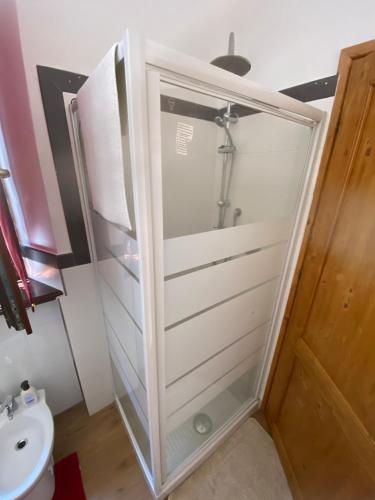 a shower with a glass door in a bathroom at B&B A due passi dal centro in Castelfidardo