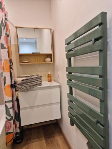a bathroom with a dresser and a mirror at Cozy studio proche plages et gare in Sanary-sur-Mer
