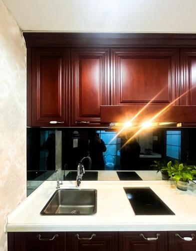 a kitchen with wooden cabinets and a sink at Pu Yu Apartment in Shanghai