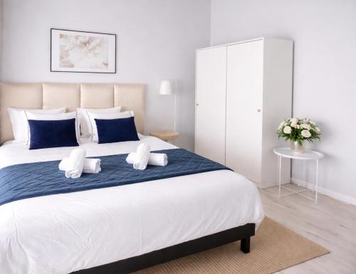 a bedroom with a large white bed with two pillows at Iris Home in Székesfehérvár