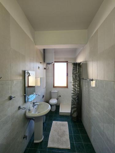 a bathroom with a sink and a toilet at Jozi Kaiser Apartment 4 in Durrës