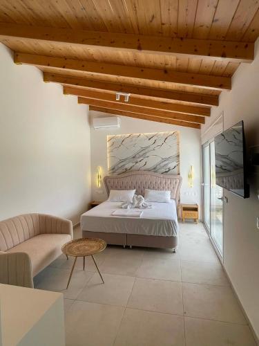 a bedroom with a bed and a couch and a tv at Sofi Hotel in Neokhórion
